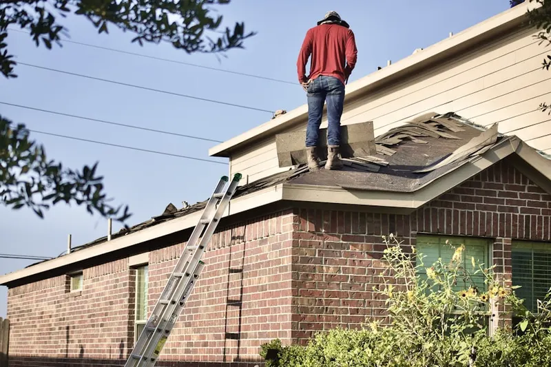 Professional roofer working on a residential roof in North College Park